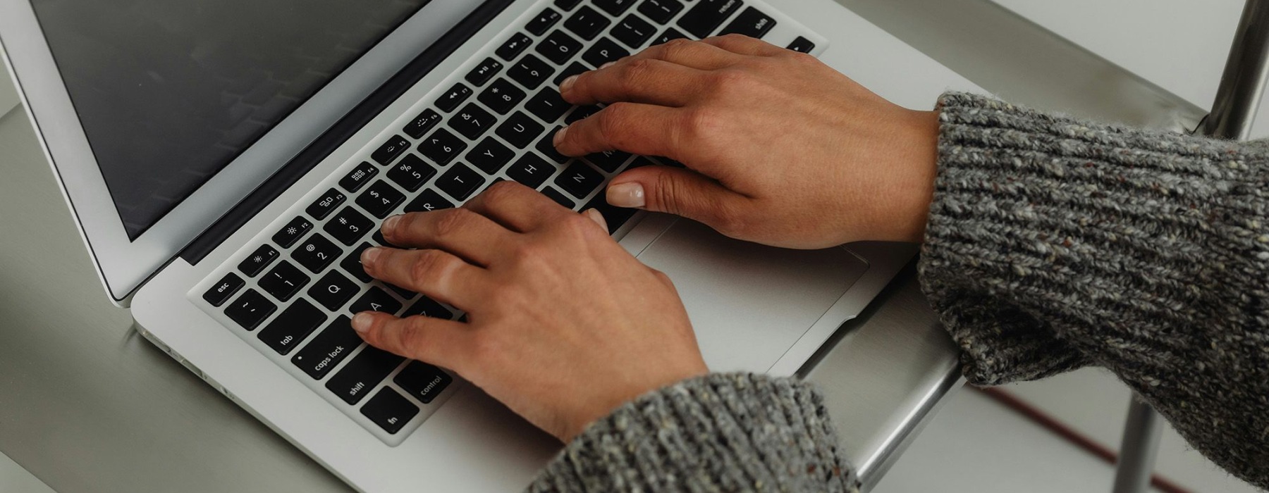 a person typing on a laptop